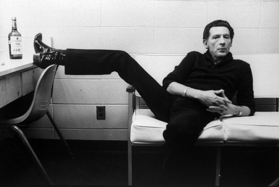 Singer Jerry Lee Lewis lounging on couch w. one foot up on dressing table next to a bottle of Seagram's V.O. whiskey in dressing room at Performing Arts Center.    (Photo by Thomas S. England/Getty Images)