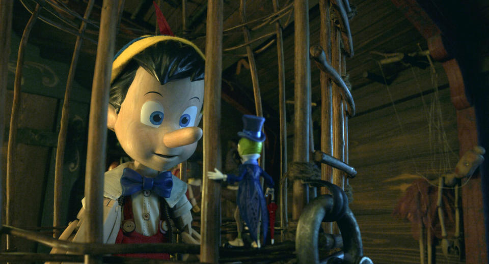 This image released by Disney shows Pinocchio, voiced by Benjamin Evan Ainsworth, left, and Jiminy Cricket, voiced by Joseph Gordon-Levitt, in Disney's live-action film "Pinocchio." (Disney via AP)