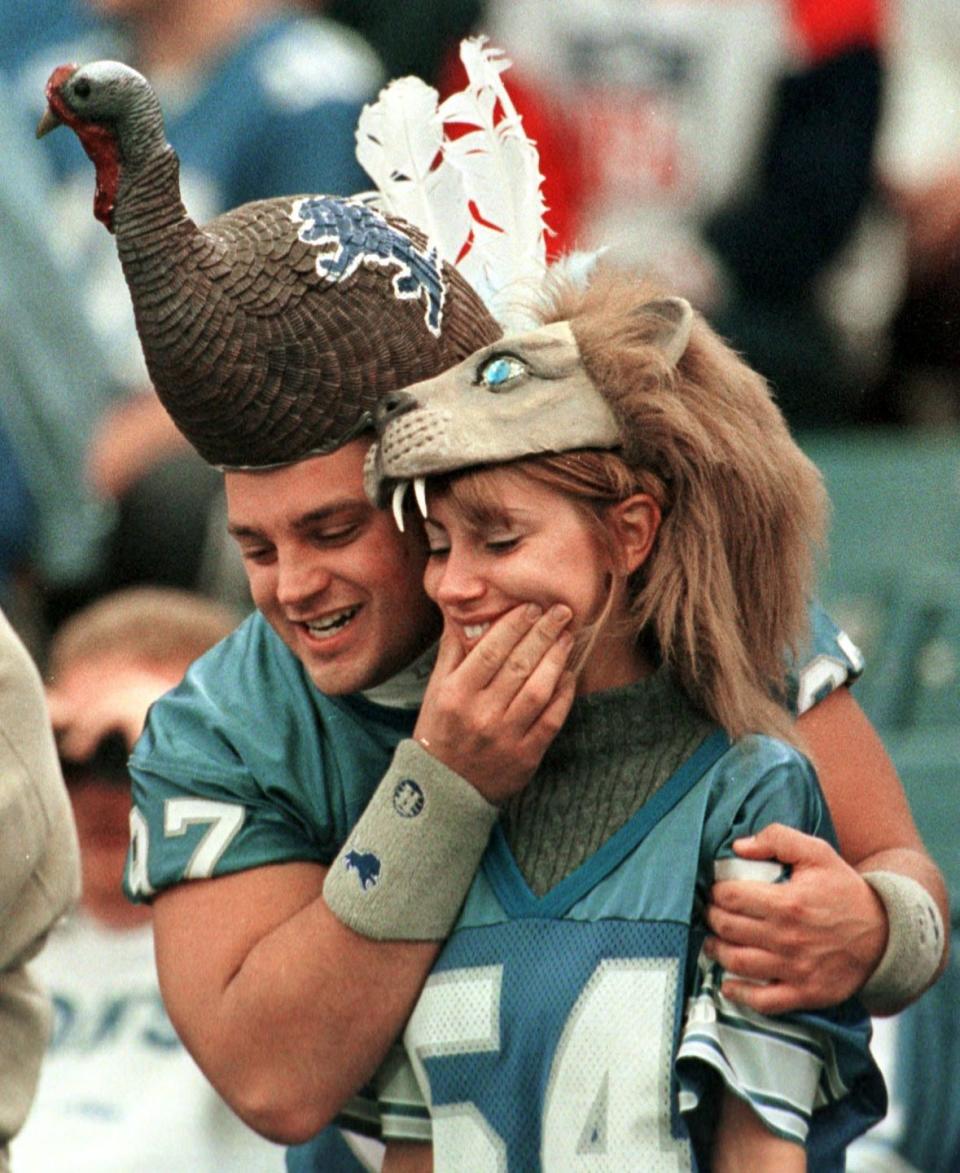 Fans Jerry Bac and Amy Cruc wear comical headgear