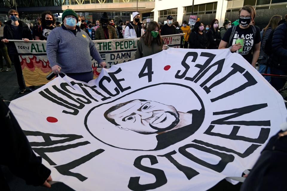 Demonstrators gather outside the Hennepin County Government Center, Monday, March 8, 2021, in Minneapolis where the trial for former Minneapolis police officer Derek Chauvin is delayed. Chauvin is charged with murder in the death of George Floyd during an arrest last May in Minneapolis. 