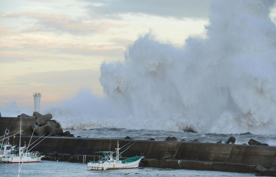 High waves hit a breakwater in Kihocho, Mie prefecture, western Japan Sunday, Sept. 30, 2012. A powerful typhoon is heading to Tokyo after injuring dozens of people, causing blackouts and paralyzing traffic in southern Japan. (AP Photo/Kyodo News) JAPAN OUT, MANDATORY CREDIT, NO LICENSING IN CHINA, FRANCE, HONG KONG, JAPAN AND SOUTH KOREA