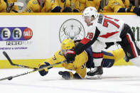 Ottawa Senators right wing Jayce Hawryluk (79) and Nashville Predators defenseman Roman Josi (59), of Switzerland, battle for the puck in the first period of an NHL hockey game Tuesday, Feb. 25, 2020, in Nashville, Tenn. (AP Photo/Mark Humphrey)