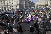 Cardinal Angelo De Donatis, the pope's vicar for Rome, at center with white cap, greets relatives of Italy's ambassador to the Democratic Republic of Congo Luca Attanasio and Italian Carabinieri police officer Vittorio Iacovacci, after presiding over their solemn funeral, in Rome's Santa Maria degli Angeli Church, Thursday, Feb. 25, 2021. Italy paid tribute Thursday to its ambassador to Congo and his bodyguard who were killed in an attack on a U.N. convoy, honoring them with a state funeral and prayers for peace in Congo and all nations "torn by war and violence." (AP Photo/Andrew Medichini)