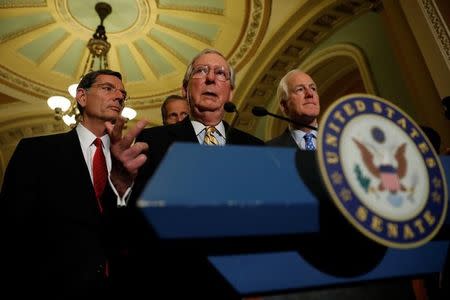 Senate Majority Leader Mitch McConnell, accompanied by Senator John Cornyn (R-TX) and Senator John Barrasso (R-WY), speaks with reporters following the successful vote to open debate on a health care bill on Capitol Hill in Washington, U.S., July 25, 2017. REUTERS/Aaron P. Bernstein