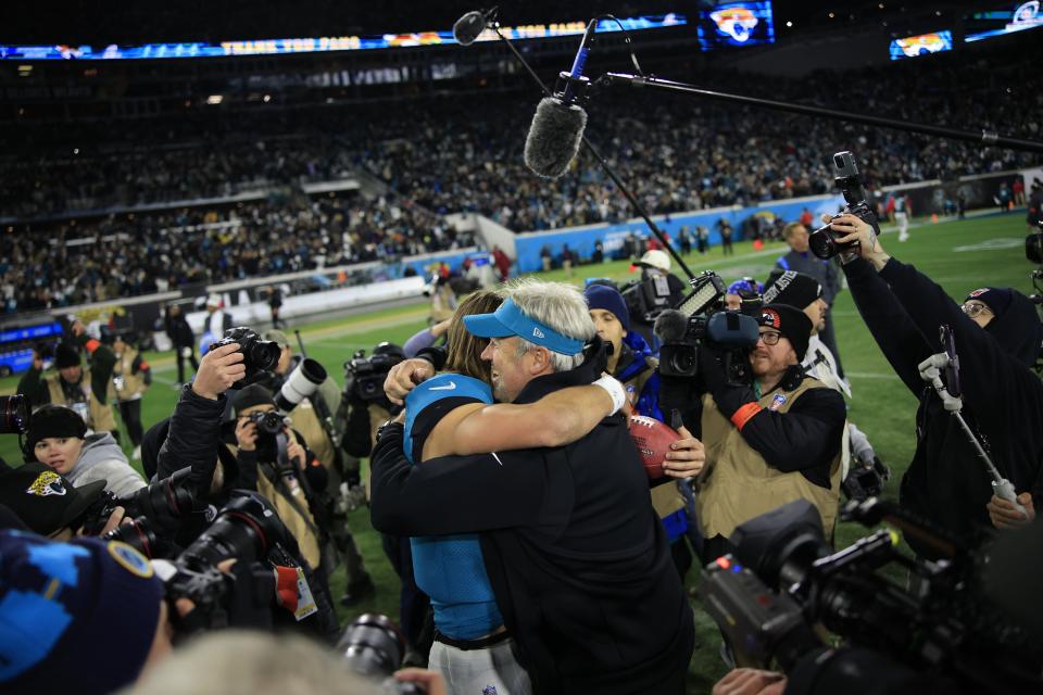 Jacksonville Jaguars head coach Doug Pederson hugs quarterback Trevor Lawrence (16) after the game of an NFL first round playoff football matchup Saturday, Jan. 14, 2023 at TIAA Bank Field in Jacksonville, Fla. Jacksonville Jaguars edged the Los Angeles Chargers on a field goal 31-30. [Corey Perrine/Florida Times-Union]