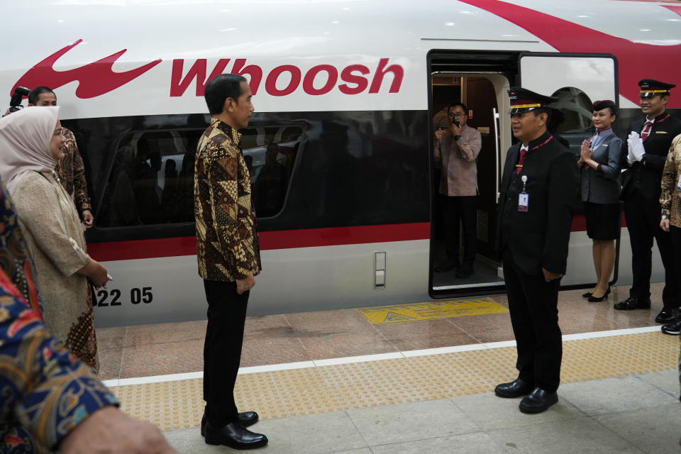 Indonesian President Joko widodo, left, talks to official during the opening ceremony for launching Southeast Asia's first high-speed railway at Halim station in Jakarta, Indonesia, Monday, Oct. 2, 2023. Indonesian President Joko Widodo launched Southeast Asia's first high-speed railway that will start its commercial operations on Monday, a key project under China's Belt and Road infrastructure initiative that will cut travel time between two cities from the current three hours to about 40 minutes. (AP Photo/Achmad Ibrahim)