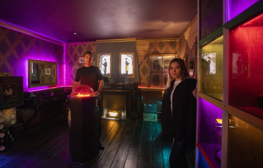 A man and a woman standing inside a colorful room