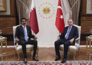 Turkey's President Recep Tayyip Erdogan, right, and Qatar's Emir Sheikh Tamim bin Hamad Al Thani pose for a photo before their talks in Ankara, Turkey, Wednesday, Aug. 15, 2018. Sheikh Al Thani is in Turkey for a one-day working visit.(Presidential Press Service via AP, Pool)