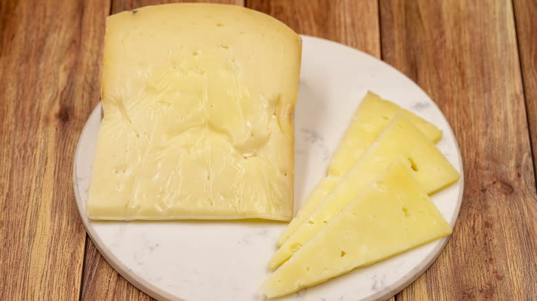 Gruyere cheese on white plate 