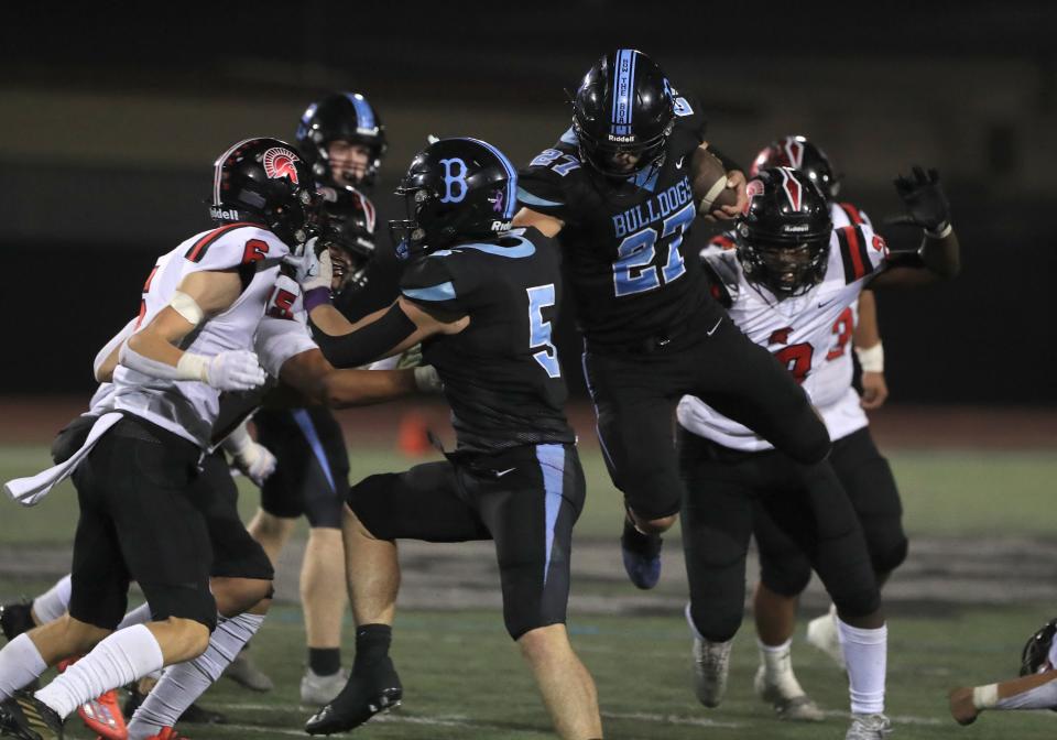 Buena's Zane Carter leaps through an opening in the Rio Mesa defense during the fourth quarter of their Channel League game on Friday, Sept. 30, 2022, at Buena High. Rio Mesa won 14-13.