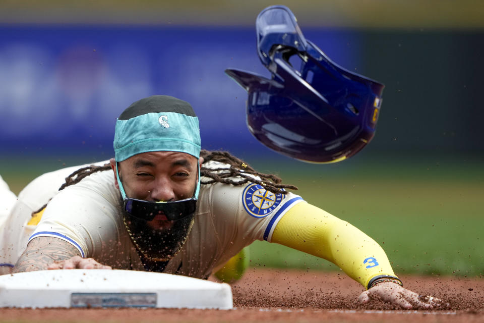 Seattle Mariners' J.P. Crawford slides into third base safely on a single by Julio Rodríguez against the Minnesota Twins during the first inning of a baseball game Sunday, June 30, 2024, in Seattle. (AP Photo/Lindsey Wasson)