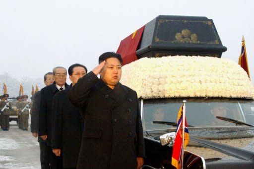 This handout picture taken by North Korea's official Korean Central News Agency (KCNA) on December 28, shows Kim Jong-Un (C) salutes besides the convoy carrying the body of his father and late leader Kim Jong-Il at Kumsusan Memorial Palace in Pyongyang. North Korea said Saturday its new leader Kim Jong-Un has formally been appointed supreme commander of the 1.2 million-strong military