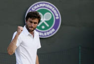 Gilles Simon of France celebrates after winning the third set during his match against Gael Monfils of France at the Wimbledon Tennis Championships in London, July 4, 2015. REUTERS/Stefan Wermuth