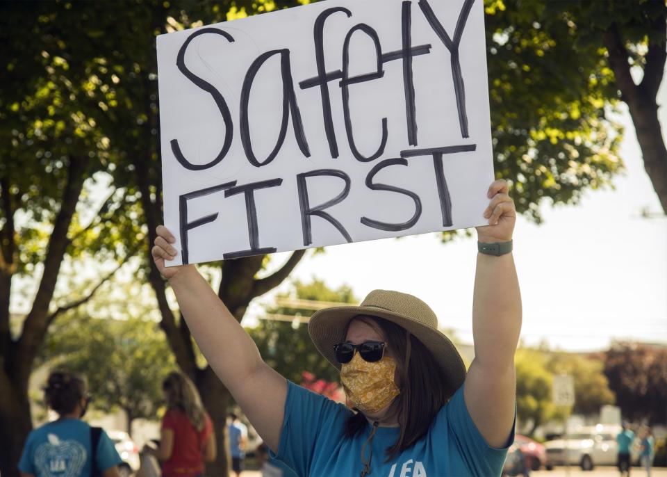 Larson Elementary School teacher Cyndi Reichert protests in front of the Lodi Unified School District offices in California over the reopening of schools planned for Aug. 3.