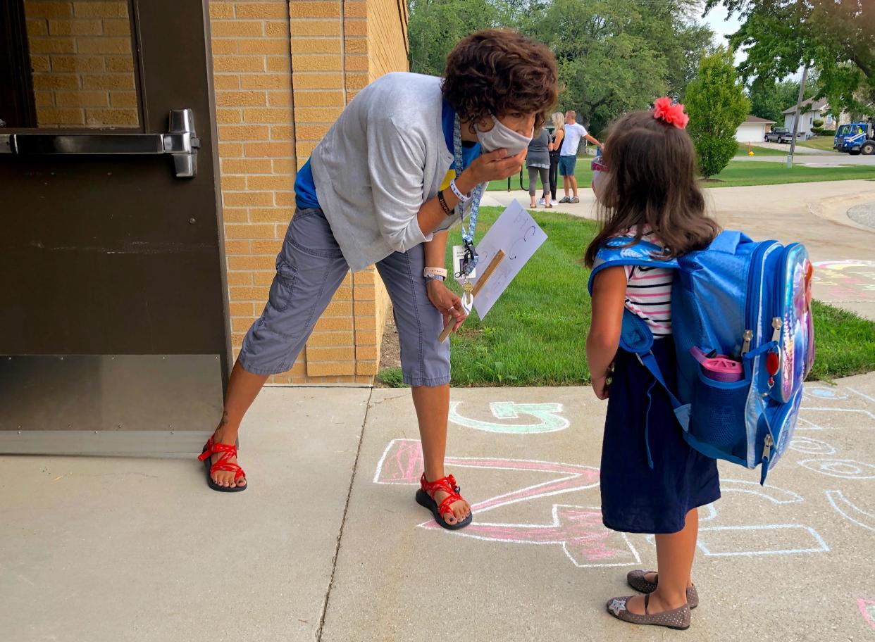 Special Education Paraprofesional Dawn Ward at New Groningen Elementary in Zeeland helps a student find her classroom on the school's first day of class Tuesday, Sept. 1, 2020.