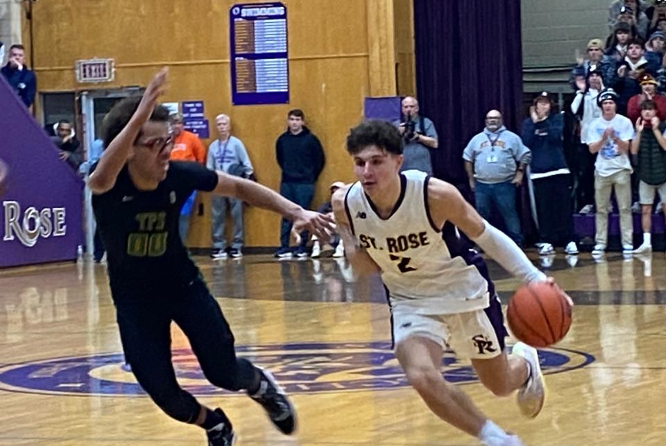 St. Rose's Peter Mauro (2) drives by the Patrick School's Marqiis Samuels during the Purple Roses' 53-49 win on Jan. 16, 2023.