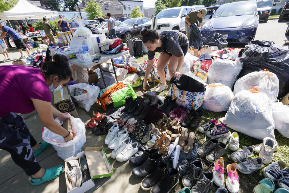 Volunteers with a Seventh Day Adventist church sort donated items to be distributed people in need after remnants of Hurricane Ida inundated the community, Saturday, Sept. 4, 2021, in Mamaroneck, N.Y. More than four days after the hurricane blew ashore in Louisiana, Ida's rainy remains hit the Northeast with stunning fury on Wednesday and Thursday, submerging cars, swamping subway stations and basement apartments and drowning scores of people in five states. (AP Photo/Mary Altaffer)