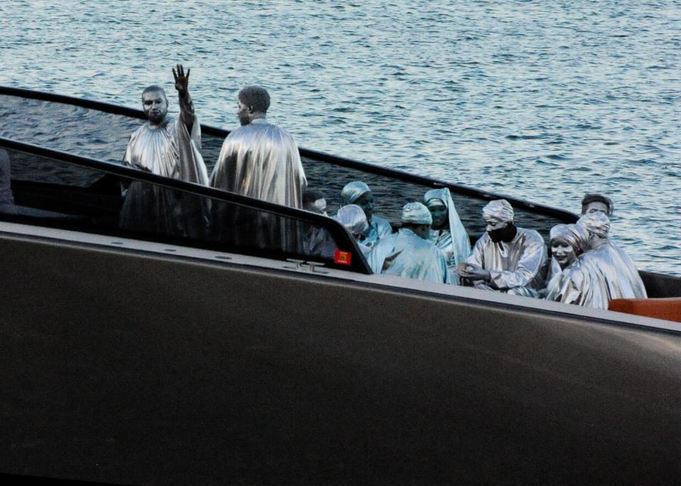 Kanye West on a yacht departing from his "Mary" performance with performers