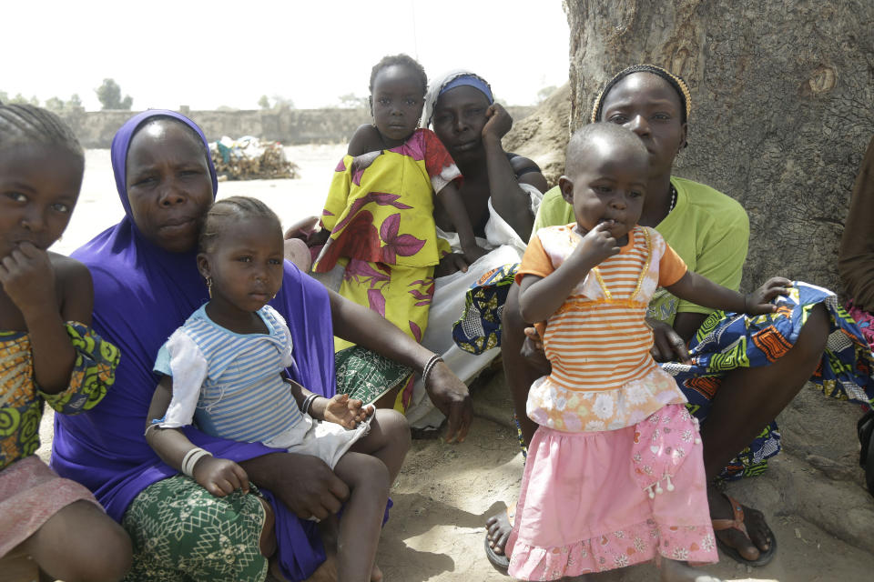 In this photo taken on Monday, Feb. 18, 2019, Woman and their children displaced by Islamist extremist sit in the shade at Malkohi camp in Yola, Nigeria. For those who live in the makeshift camp for Nigerians who have fled Boko Haram violence, the upcoming presidential vote isn’t a topic of conversation, because nearly all are more worried about putting food on the table.AP Photo/ Sunday Alamba)