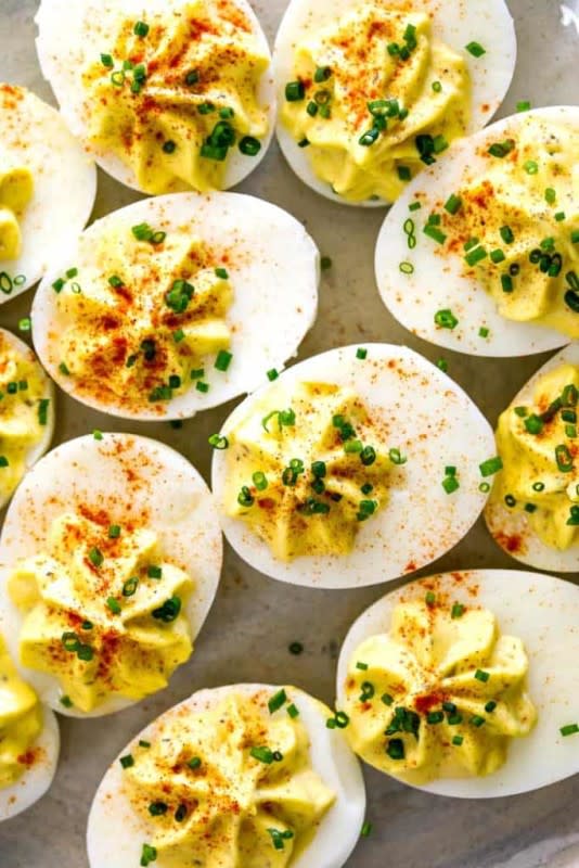 <p>Grandbaby Cakes</p><p>These Divine Eggs are made perfectly with creamy Miracle Whip, tangy mustard and sweet relish—the BEST Classic Deviled Eggs recipe that is sure to impress. An Easter and holiday MUST!</p><p><strong>Get the recipe: <a href="https://grandbaby-cakes.com/deviled-eggs/" rel="nofollow noopener" target="_blank" data-ylk="slk:The Best Deviled Eggs (Divine Eggs);elm:context_link;itc:0;sec:content-canvas" class="link ">The Best Deviled Eggs (Divine Eggs)</a></strong></p>