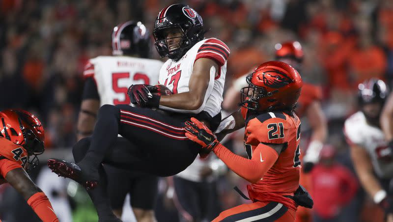 Utah wide receiver Devaughn Vele is tackled by Oregon State linebacker Melvin Jordan IV (44) and defensive back Noble Thomas (21) during game Friday, Sept. 29, 2023, in Corvallis, Ore. Oregon State won 21-7.