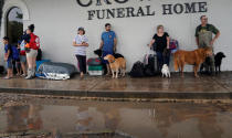 <p>People wait outside a funeral home to evacuate from flood waters from Hurricane Harvey in Dickinson, Texas Aug. 27, 2017. (Photo: Rick Wilking/Reuters) </p>