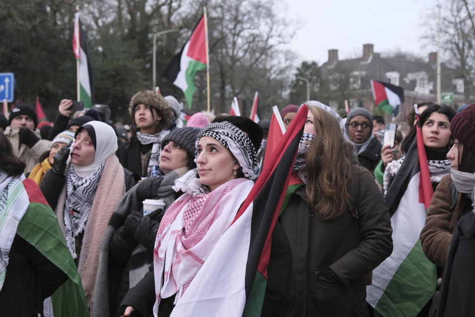 Protestors watch proceedings of a hearing on a giant video screen during a demonstration outside the International Court of Justice in The Hague, Netherlands, Thursday, Jan. 11, 2024. The United Nations' top court opens hearings Thursday into South Africa's allegation that Israel's war with Hamas amounts to genocide against Palestinians, a claim that Israel strongly denies. (AP Photo/Patrick Post)