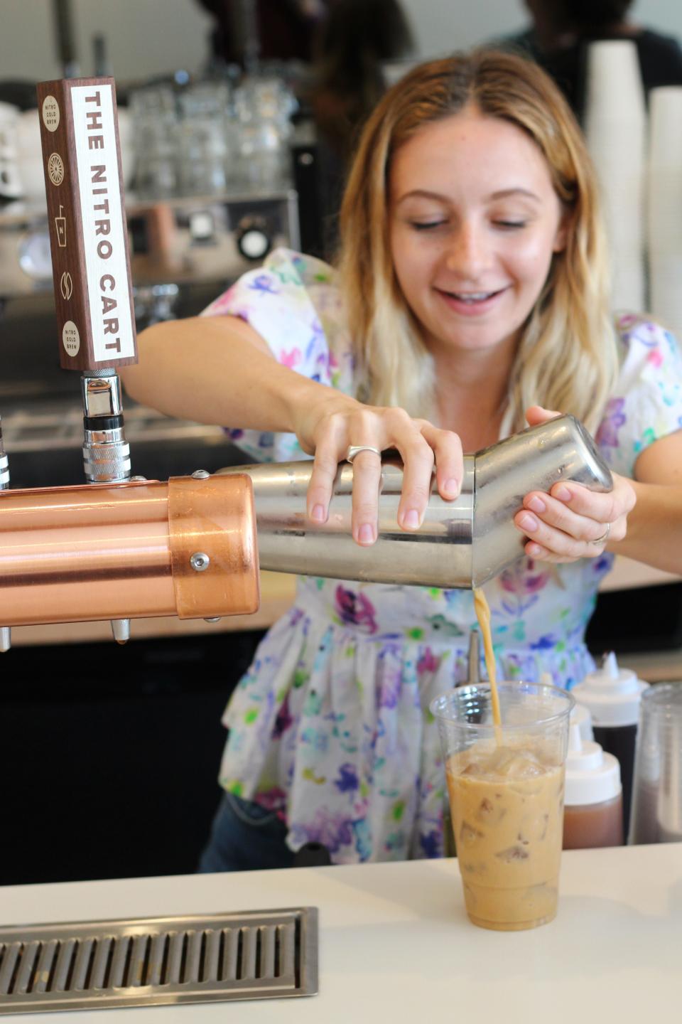 Audrey Finocchario, co-owner of the Nitro Bar in Newport, mixes up a craft coffee drink in 2019.