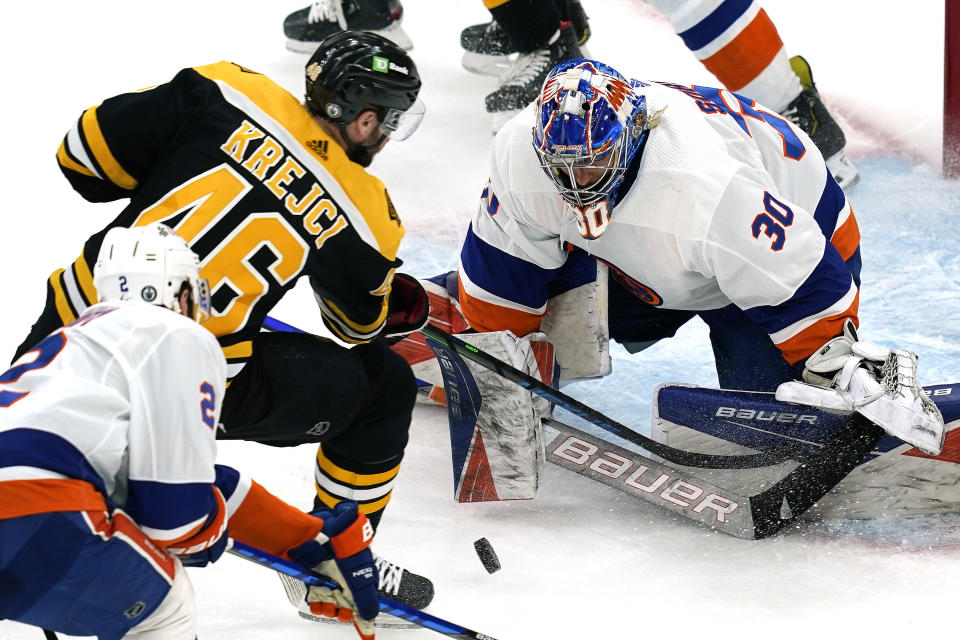 New York Islanders goaltender Ilya Sorokin (30) keeps the puck in front as Boston Bruins center David Krejci (46) tries to score in the first period of Game 1 during an NHL hockey second-round playoff series, Saturday, May 29, 2021, in Boston. (AP Photo/Elise Amendola)