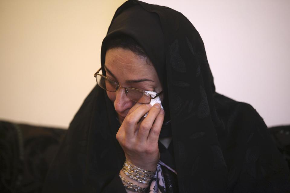 In this picture taken on Monday, April 28, 2014, Iranian woman Samereh Alinejad wipes away tears at her home while talking about her son who was killed in a street brawl in the city of Royan about 146 miles (235 kilometers) north of the capital Tehran, Iran. Alinejad tells The Associated Press that she had felt she could never live with herself if the man who killed her son were spared from execution. But in the last moment, she pardoned him in an act that has made her a hero in her hometown, where banners in the streets praise her family’s mercy. (AP Photo/Vahid Salemi)