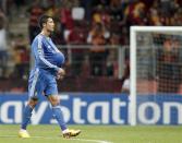 Real Madrid's Cristiano Ronaldo walks on the pitch with the ball under his jersey after their Champions League Group B soccer match against Galatasaray at Turk Telekom Arena in Istanbul September 17, 2013. REUTERS/Osman Orsal