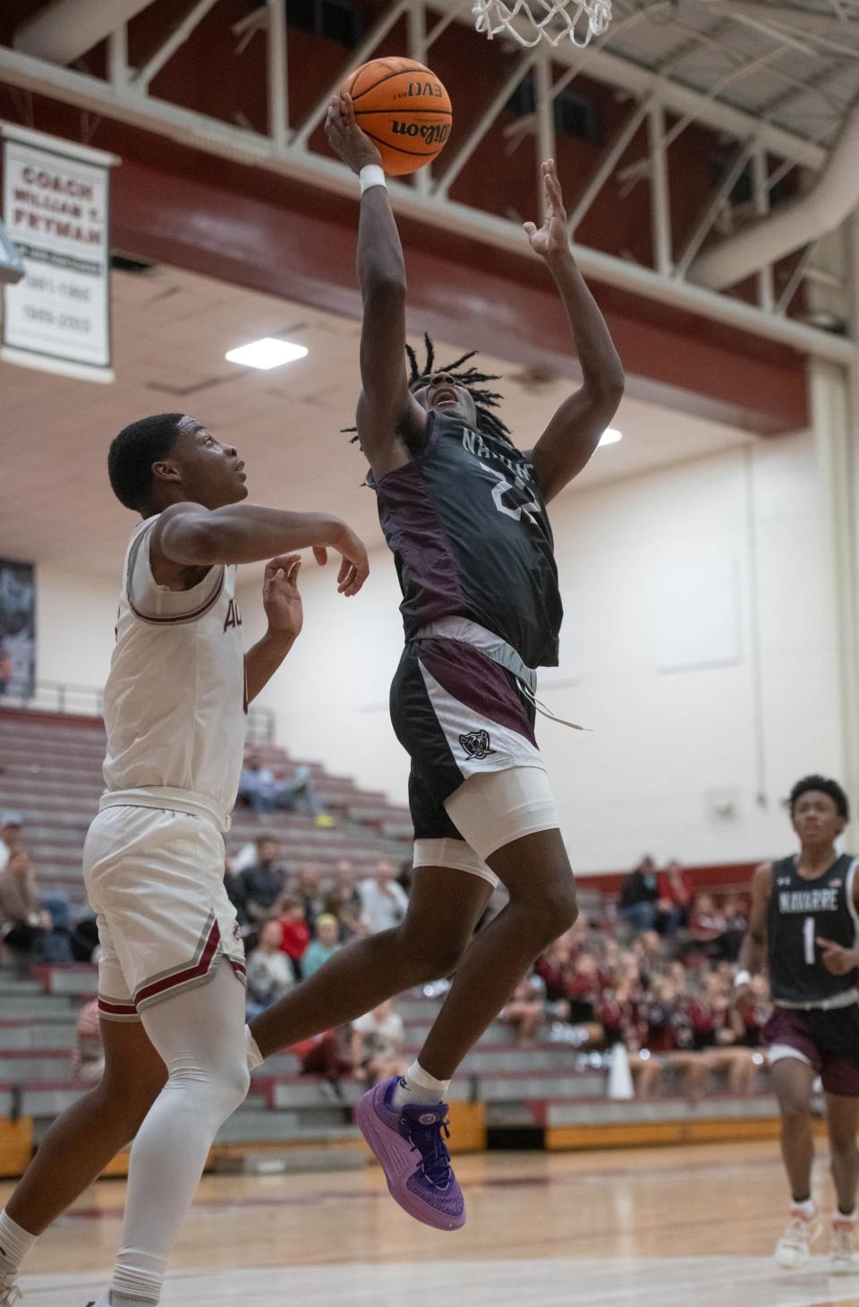 Darius Cunningham (22) shoots during the Navarre vs Tate boys basketball game at Tate High School on Friday, Jan. 12, 2024.