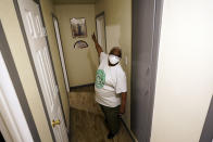 Doris Brown talks about the repairs made from the flood damage to her home Friday, July 31, 2020, in Houston. Brown's home flooded during Harvey and she's part of a group called the Harvey Forgotten Survivors Caucus. (AP Photo/David J. Phillip)