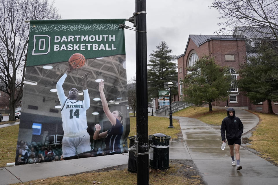 A student walks near the Alumni Gymnasium on the campus of Dartmouth College, Tuesday, March 5, 2024, in Hanover, N.H. Dartmouth basketball players voted to form a union, an unprecedented step in the continued deterioration of the NCAA's amateur business model. (AP Photo/Robert F. Bukaty)