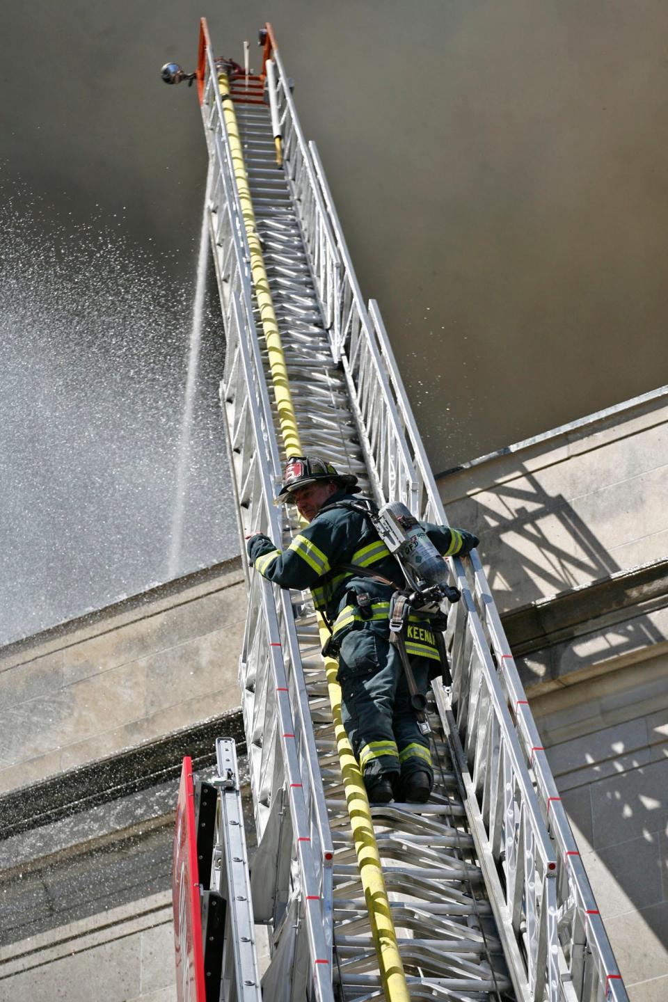 Firefighters battle flames at the former Masonic Temple in Quincy in September 2013.