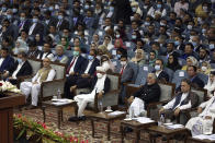 Afghan President Ashraf Ghani, center, wearing a protective face mask to help curb the spread of the coronavirus attends an Afghan Loya Jirga meeting in Kabul, Afghanistan, Friday, Aug. 7, 2020. The traditional council opened Friday in the Afghan capital to decide the release of a final 400 Taliban - the last hurdle to the start of negotiations between Kabul’s political leadership and the Taliban in keeping with a peace deal the United States signed with the insurgent movement in February. (AP Photo/Rahmat Gul)