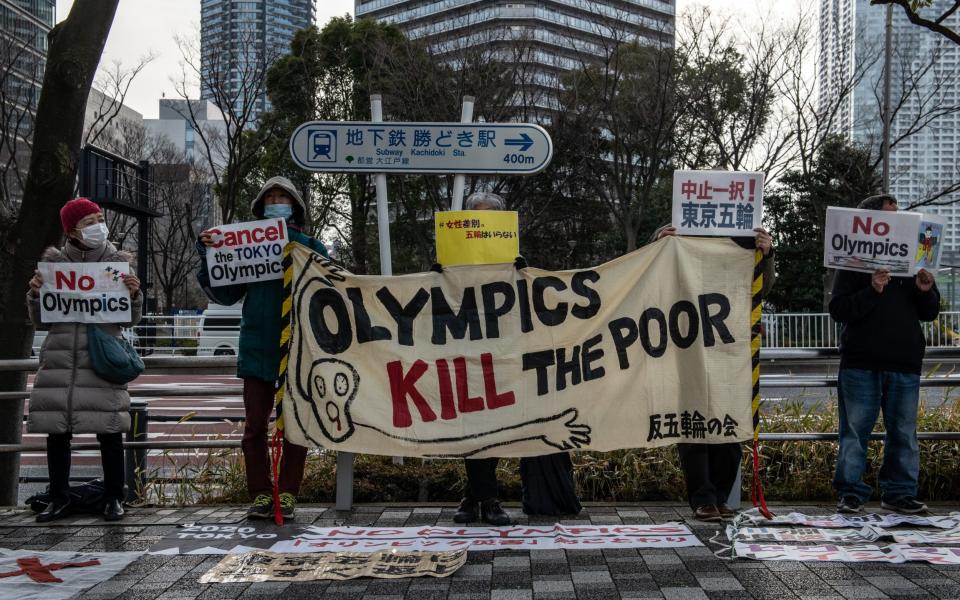 Protesters hold banners as they call for the Tokyo Olympics to be cancelled. Polls have indicated that a large percentage of Japanese oppose holding the postponed Olympics this summer amid the continuing coronavirus pandemic. - Carl Court/Getty Images