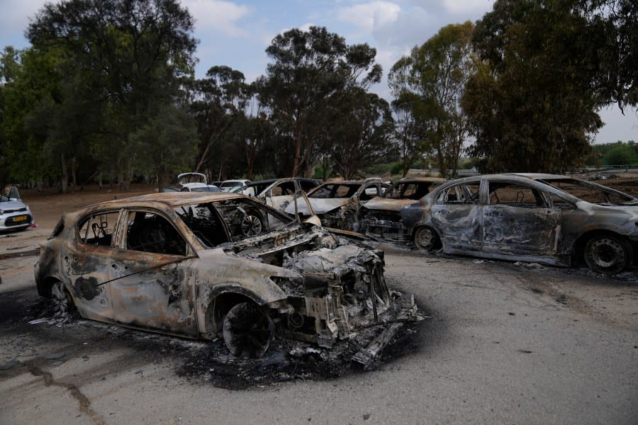 Destroyed cars are seen at the rave party site near the Kibbutz Re’im, close to the Gaza Strip border fence, on Tuesday, Oct.10, 2023. Israel’s rescue service Zaka said paramedics had recovered at least 260 bodies of people killed in a surprise attack by Hamas militants Saturday. (AP Photo/Ohad Zwigenberg)