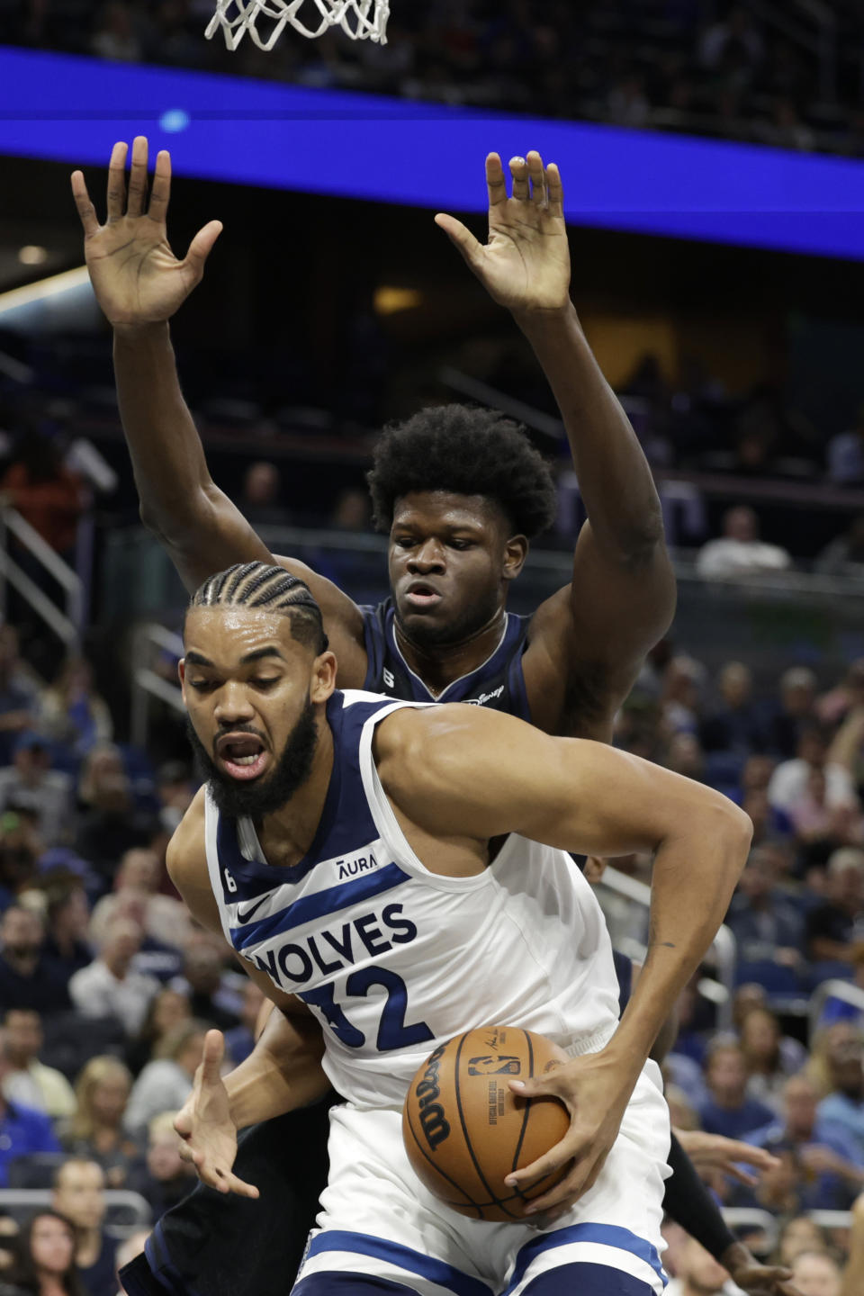 Minnesota Timberwolves center Karl-Anthony Towns (32) is defended under the basket by Orlando Magic center Mo Bamba during the first half of an NBA basketball game Wednesday, Nov. 16, 2022, in Orlando, Fla. (AP Photo/Kevin Kolczynski)