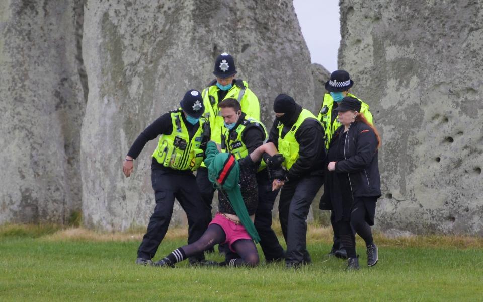 Video from the scene showed around 100 people inside the stone circle and a banner reading "Standing for Stonehenge" - Getty