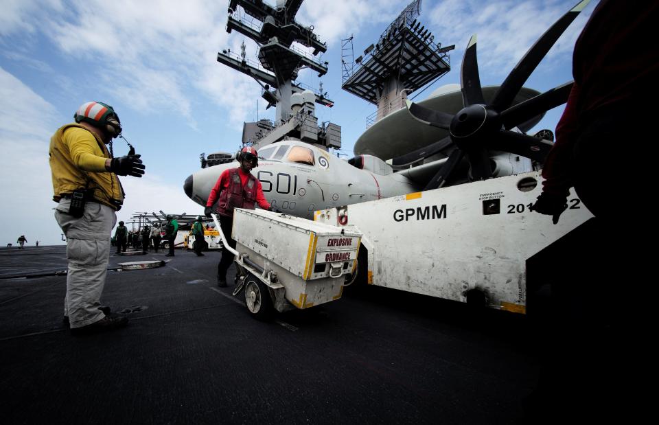 Sailors move explosive ordnance on the flight deck of the USS Dwight D. Eisenhower in the Red Sea on February 12.