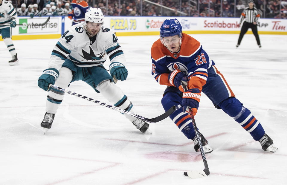 San Jose Sharks' Marc-Edouard Vlasic (44) chases Edmonton Oilers' Mattias Janmark (26) during second-period NHL hockey game action in Edmonton, Alberta, Monday, March 20, 2023. (Jason Franson/The Canadian Press via AP)