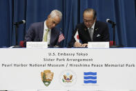 U.S. Ambassador to Japan Rahm Emanuel, left, and Hiroshima Mayor Kazumi Matsui sign a sister park arrangement between the Pearl Harbor National Memorial and the Hiroshima Peace Memorial Park at the U.S. Embassy Thursday, June 29, 2023 in Tokyo. (AP Photo/Eugene Hoshiko)