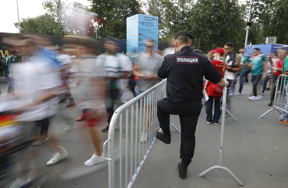 FILE - In this June 17, 2018, file photo, a Russian police officer controls an entrance ahead of the group F match between Germany and Mexico at the 2018 soccer World Cup in the Luzhniki Stadium in Moscow, Russia. A year after hosting the World Cup, Russia is boasting the biggest club soccer crowds since Soviet days and participation at the amateur level is on the rise. Still, there are signs of trouble for the sport. (AP Photo/Alexander Zemlianichenko, File)