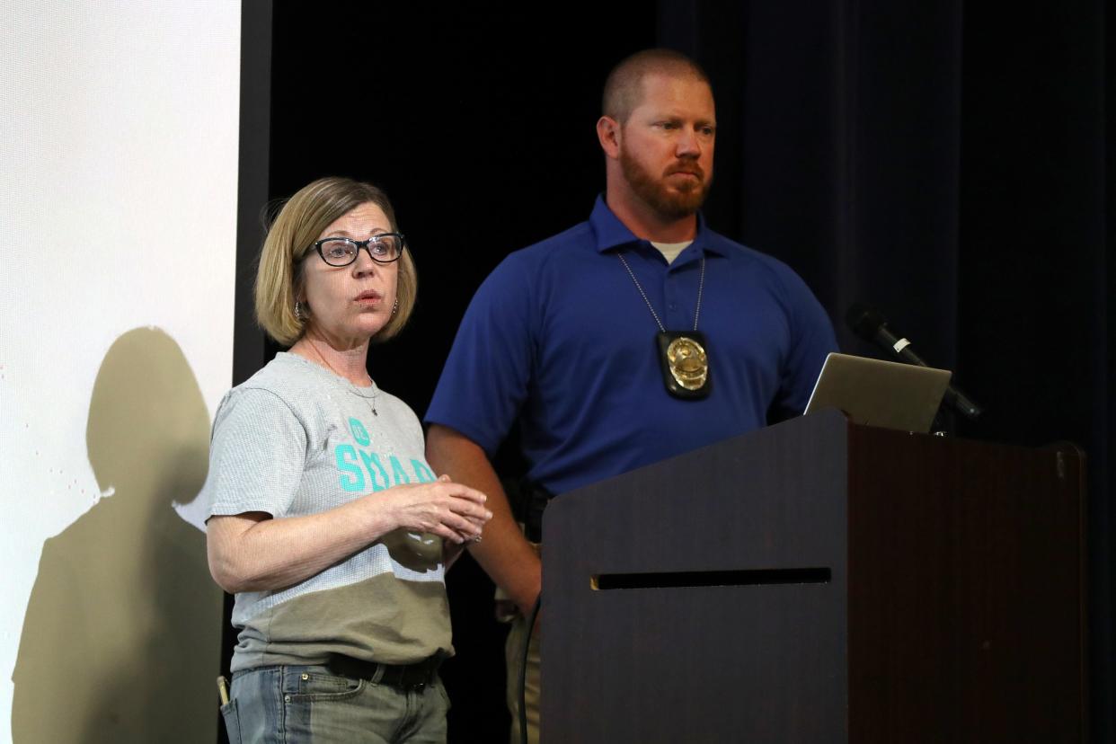 Deborah Grayson (left), with Be SMART, and Bexley police Detective Darren Briley give a gun safety presentation May 16 at Bexley City Schools’ Cassingham Theater.