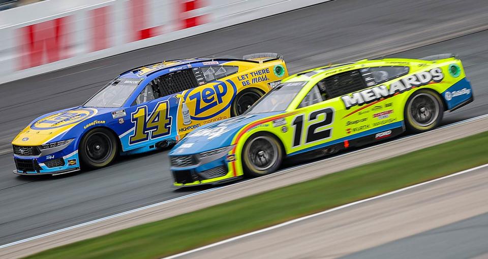 Chase Briscoe, in the No. 14 Ford, races ahead of Ryan Blaney in the No. 12 Ford at New Hampshire Motor Speedway.