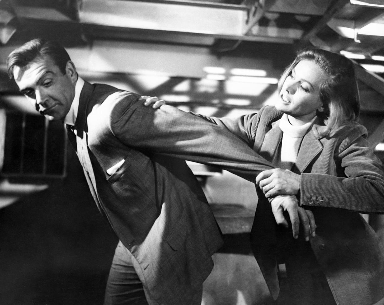 Sean Connery and Honor Blackman film a scene for Goldfinger at Pinewood Studios in Buckinghamshire. It's their first meeting, but that doesn't stop Pussy Galore from putting a restraining arm lock on James Bond. This is an incident from the new film, Goldfinger.   (Photo by PA Images via Getty Images)