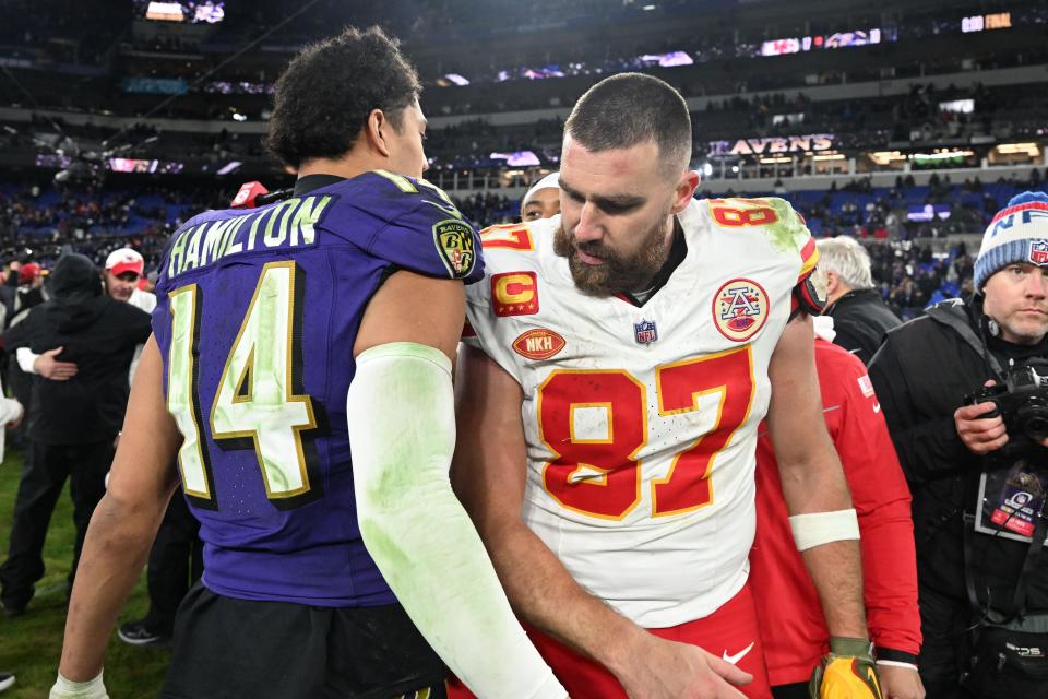 Kansas City Chiefs tight end Travis Kelce (87) greets Baltimore Ravens safety Kyle Hamilton (14) after their AFC championship game at M&T Bank Stadium.