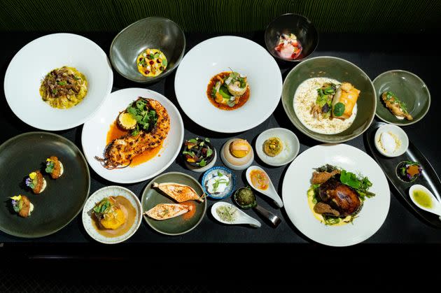 A photo shows a spread of dishes created by Portela and other chefs at the Iconoclast Dinner in New York City.