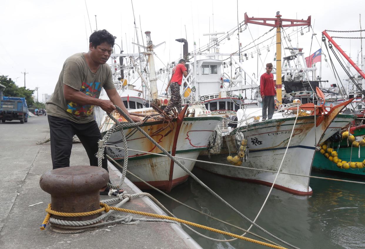 Fishermen fasten the boats as Typhoon Mawar approaches to Taiwan in Yilan County, eastern coast of Taiwan (AP)
